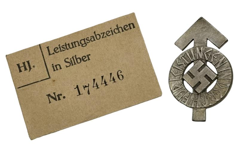 Hitler-Jugend Leistungs Rune Badge with matching numbered paper packaging