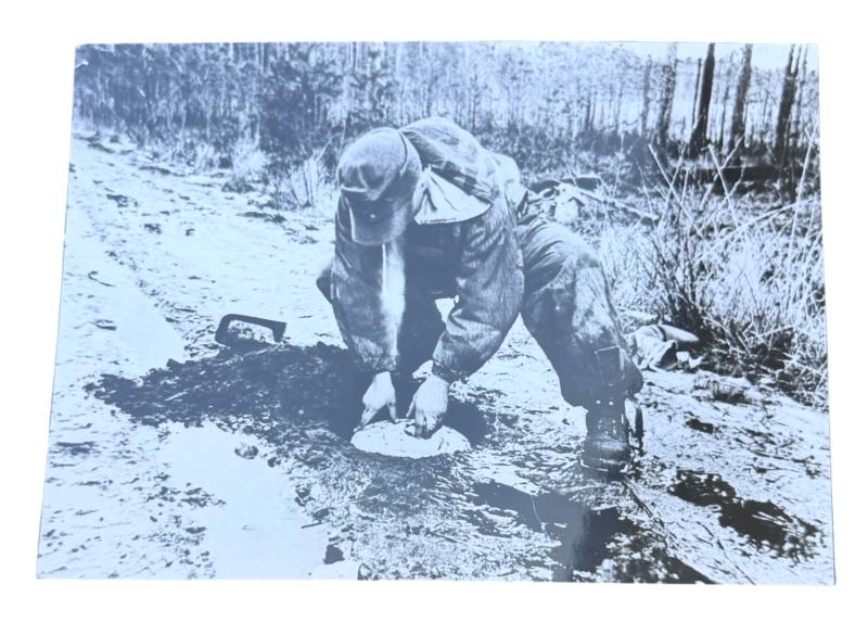 Very nice photograph of a Wehrmacht Soldier places an Anti Tank Mine