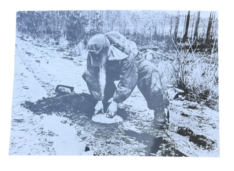 Very nice photograph of a Wehrmacht Soldier places an Anti Tank Mine